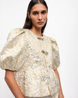 ganni Metallic Cloque Peplum Blouse gold and silver on figure side