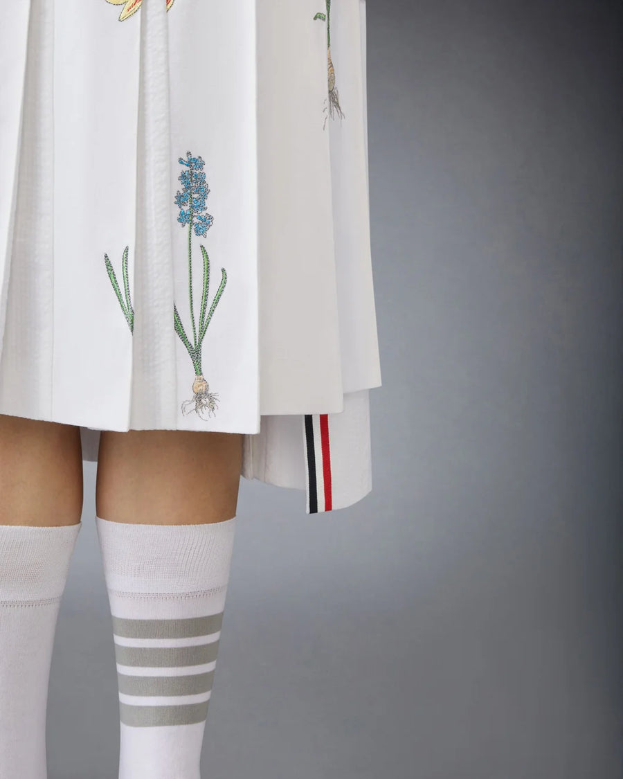 thom browne CLASSIC COTTON LINEN BOTANICAL FLOWER PLEATED SKIRT on figure front detail