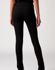 The back view of the black high-waisted pants on a woman.